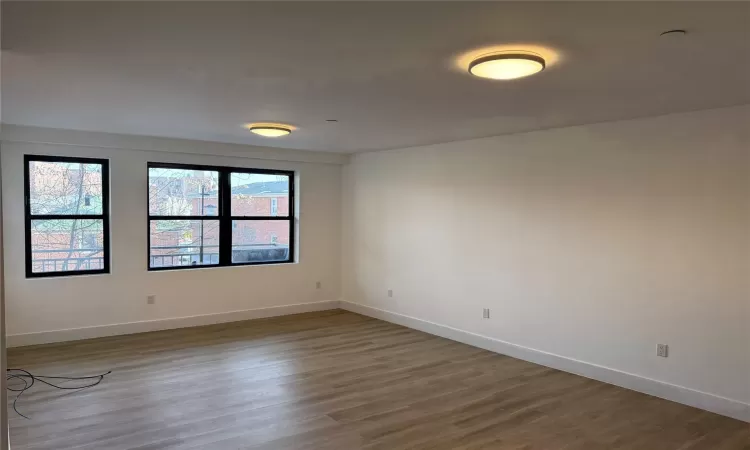 Empty room with hardwood / wood-style floors