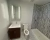 Bathroom with a shower, vanity, and toilet