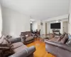 Living room with ceiling fan and hardwood / wood-style flooring