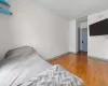 Unfurnished bedroom featuring dark wood-type flooring