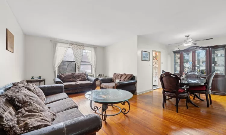 Living room with hardwood / wood-style floors and ceiling fan