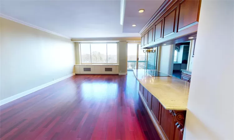 View of Open Concept Living with, Wall of Windows, Entry to Balcony, Room Featuring Crown Molding and Dark Hardwood   Flooring