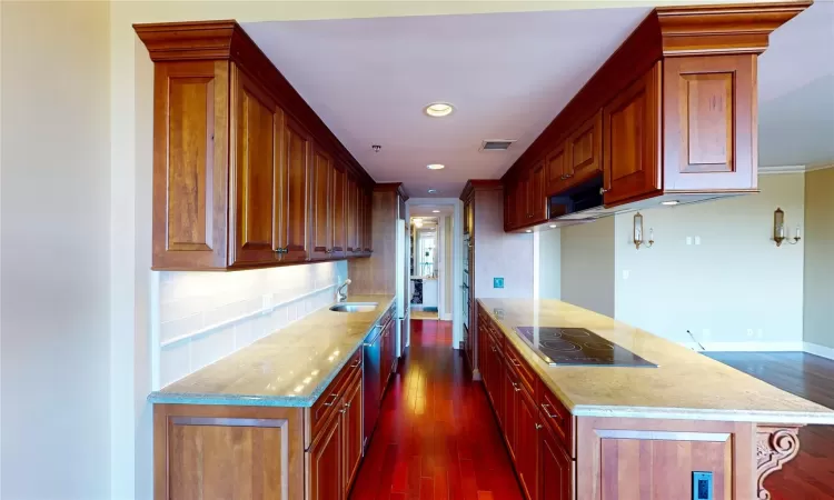 Kitchen featuring Light Granite Countertops, Sink, Electric Cooktop, Wall Oven and Breakfast Bar