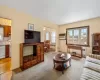 Living room featuring radiator, a chandelier, light hardwood / wood-style flooring, and a wall mounted AC