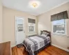 Bedroom with radiator and dark hardwood / wood-style flooring