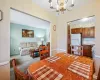 Dining area with carpet flooring and an inviting chandelier