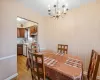 Dining space with a chandelier and light hardwood / wood-style floors