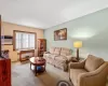 Carpeted living room featuring radiator