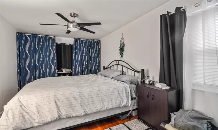 Bedroom featuring hardwood / wood-style flooring and ceiling fan