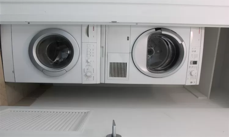 Laundry area with stacked washer / dryer