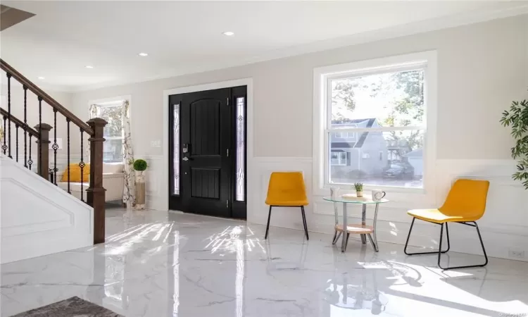 Entryway featuring ornamental molding