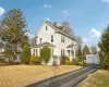 View of property with a garage and an outdoor structure