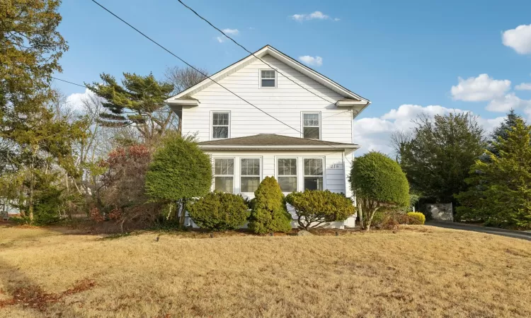 View of property exterior with a yard