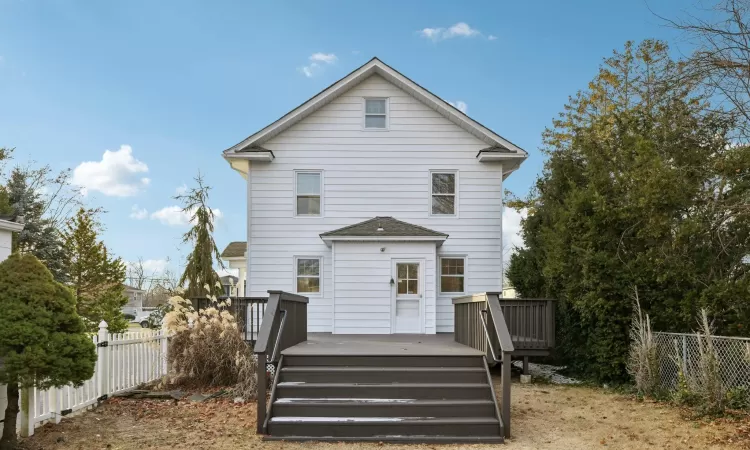 Back of house featuring a wooden deck