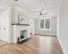 Unfurnished living room featuring a fireplace, radiator heating unit, hardwood / wood-style flooring, and coffered ceiling