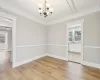 Dining room featuring ceiling fan with notable chandelier, crown molding, sink, light wood-type flooring, and beam ceiling