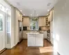 Kitchen with stainless steel appliances hanging light fixtures, decorative backsplash, a kitchen island, and appliances with stainless steel finishes