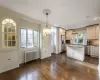 Kitchen with stainless steel appliances hanging light fixtures, decorative backsplash, a kitchen island, and appliances with stainless steel finishes