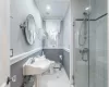 Full bathroom featuring enclosed shower, tiled floors and beautiful molding