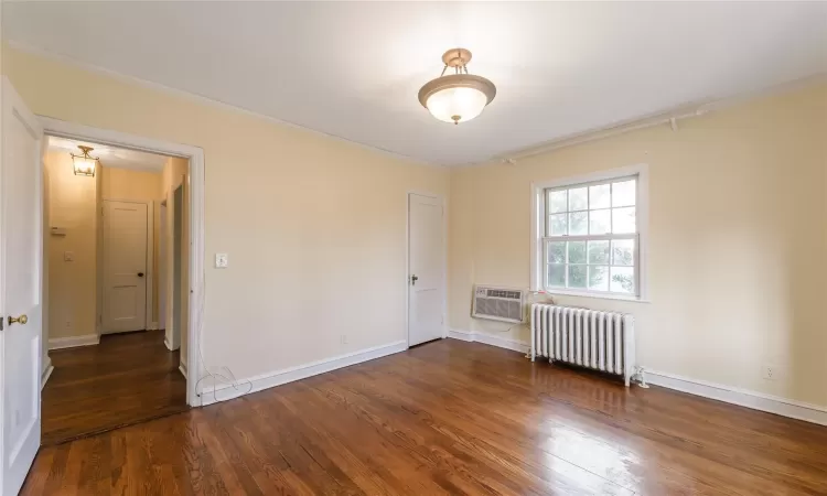 Bedroom featuring crown molding and hardwood floors