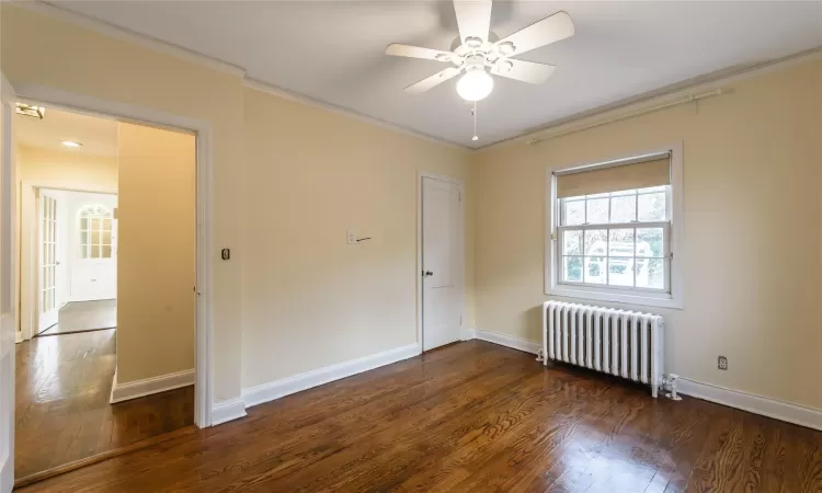 Bedroom featuring crown molding and hardwood floors