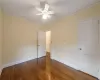 Spare room featuring crown molding, dark hardwood / wood-style flooring, and ceiling fan