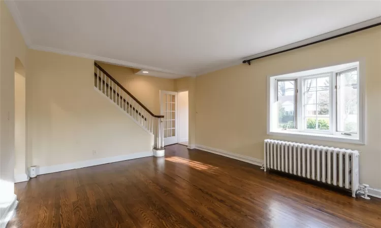 Living room featuring a fireplace, beautiful moldings and gleaming hardwood floors