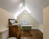 Primary bathroom featuring hardwood floors, a skylight, and a tub/shower