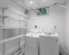 Laundry room with washer and dryer and storage