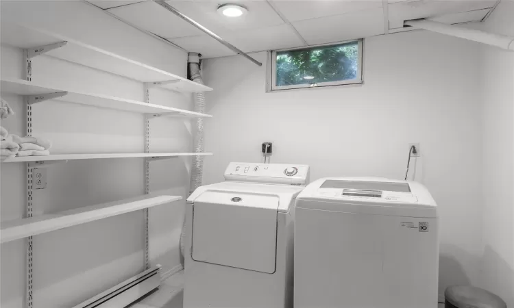 Laundry room with washer and dryer and storage