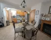 Dining room featuring a fireplace, light tile patterned floors, and an inviting chandelier