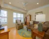 Living room with natural light hardwood / wood-style floors, plenty of natural light, crown molding, and ceiling fan