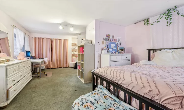 Bedroom featuring dark carpet