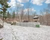 Yard covered in snow featuring a gazebo