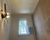 Carpeted spare room with ceiling fan, crown molding, and a baseboard radiator