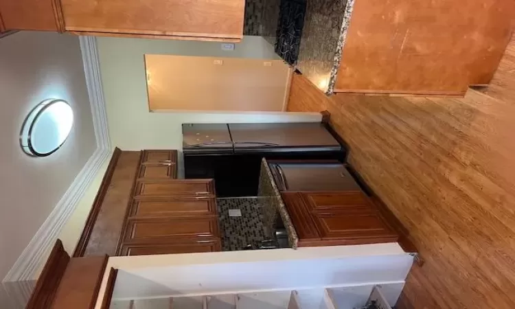 Kitchen with dishwasher, decorative backsplash, and ornamental molding