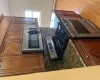 Kitchen featuring tasteful backsplash, dark stone countertops, stainless steel stove, and light wood-type flooring