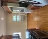 Kitchen featuring dishwasher, stacked washer and clothes dryer, decorative backsplash, dark stone countertops, and a wall mounted AC