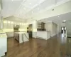 Kitchen featuring white cabinets, decorative light fixtures, tasteful backsplash, a large island, and stainless steel appliances. FOR MARKETING PURPOSES ONLY.