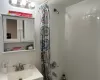 Bathroom featuring shower / bath combination with curtain, vanity, and tasteful backsplash