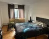 Bedroom featuring cooling unit and light hardwood / wood-style floors