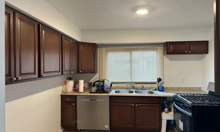 Kitchen featuring dishwasher, sink, dark brown cabinetry, and black range with gas cooktop