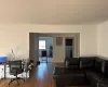 Living room featuring dark wood-type flooring and a baseboard radiator