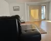 Living room with hardwood / wood-style flooring and a baseboard radiator