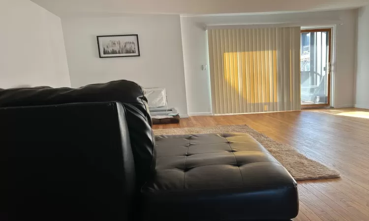 Living room with hardwood / wood-style flooring and a baseboard radiator