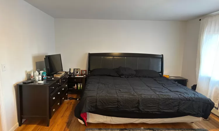 Bedroom with light hardwood / wood-style flooring