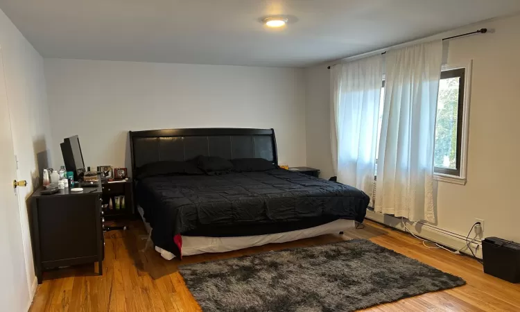 Bedroom with hardwood / wood-style floors