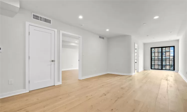 Unfurnished room with light hardwood / wood-style floors