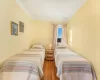 Bedroom featuring hardwood / wood-style floors and ornamental molding