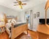 Bedroom featuring radiator, light hardwood / wood-style floors, ceiling fan, and crown molding